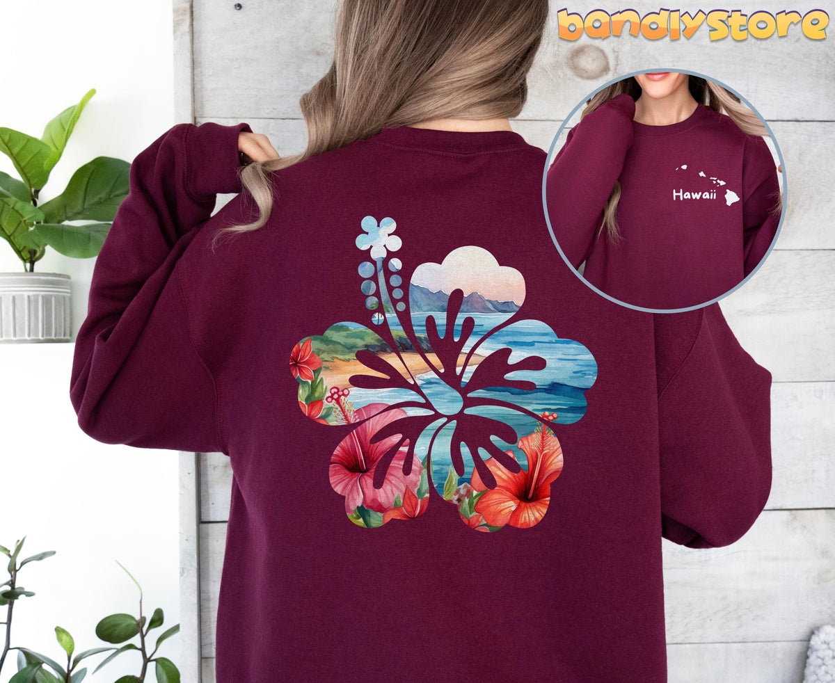 Hawaii Hibiscus Sweatshirt with Back Print in maroon from behind next to plants on wood wall with front inset.