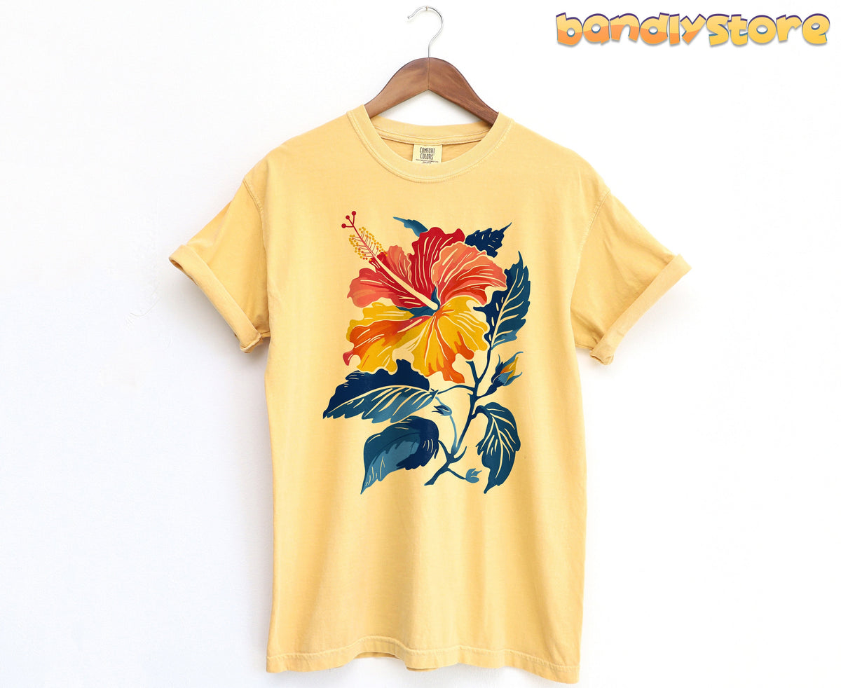 Hibiscus Flower T-Shirt in mustard hanging on a wooden hanger against a white wall.