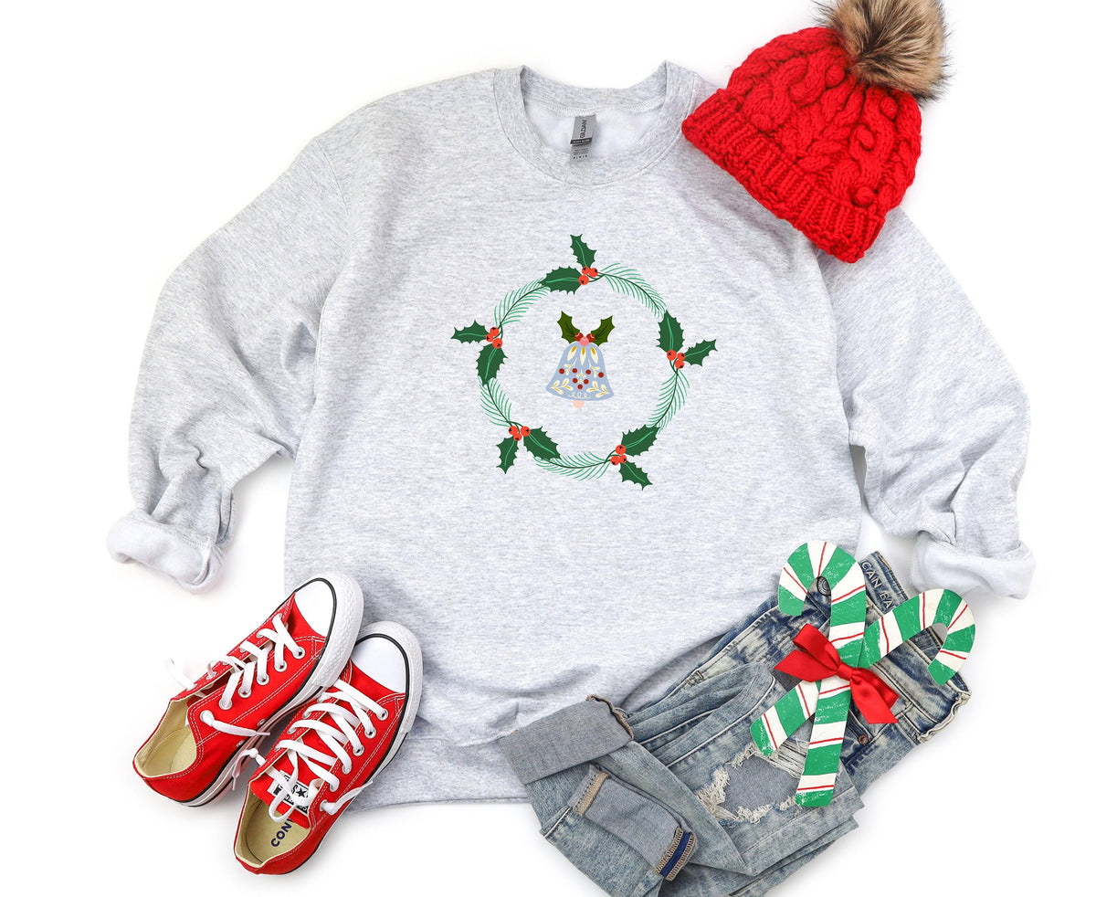 Holly Wreath Sweatshirt in ash laid flat with a red beanie, red sneakers, jeans and candy canes.
