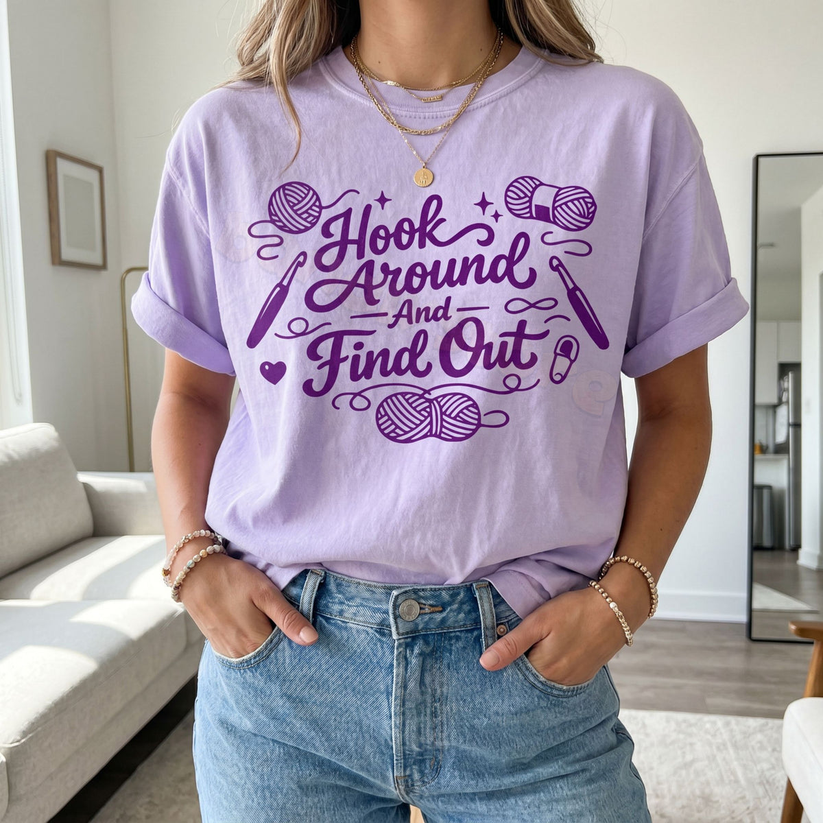 Hook Around And Find Out T-Shirt in orchid on a person facing forward in a living room with sofa and mirror.