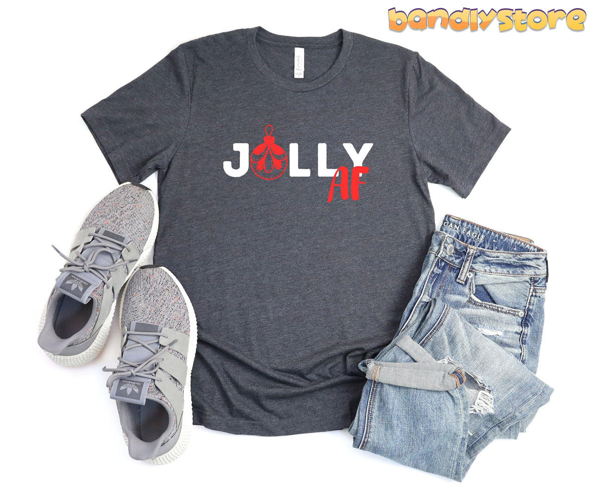 Jolly AF T-Shirt in Dark Grey Heather, flat-laid with grey sneakers left and ripped blue jeans right.