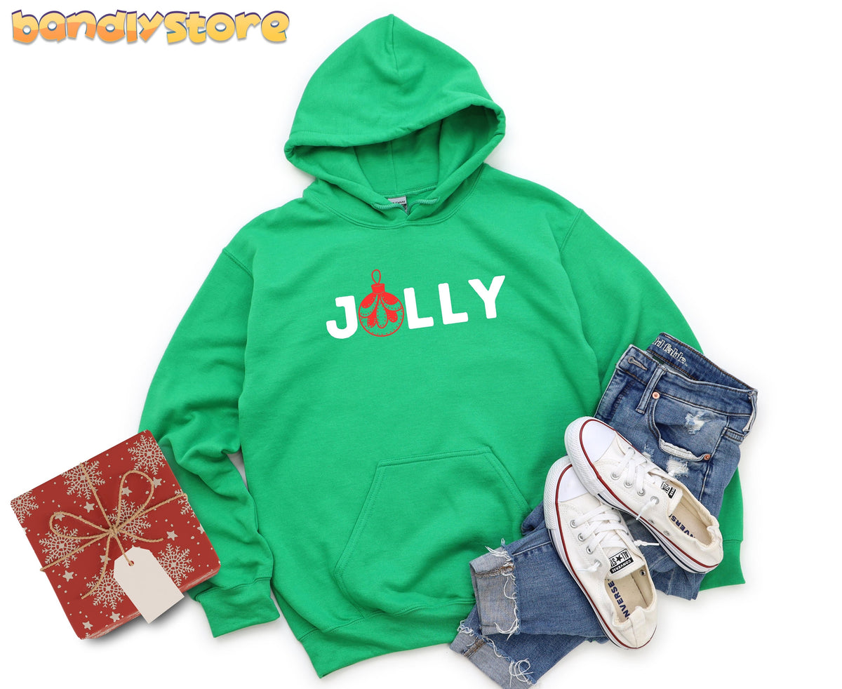 Feeling Jolly Christmas Hoodie in Irish Green flat-laid on white with gift, jeans and sneakers.