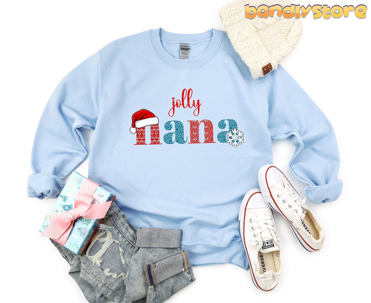 Jolly Nana Sweatshirt in light blue laid flat with beanie, gift box, jeans and sneakers.
