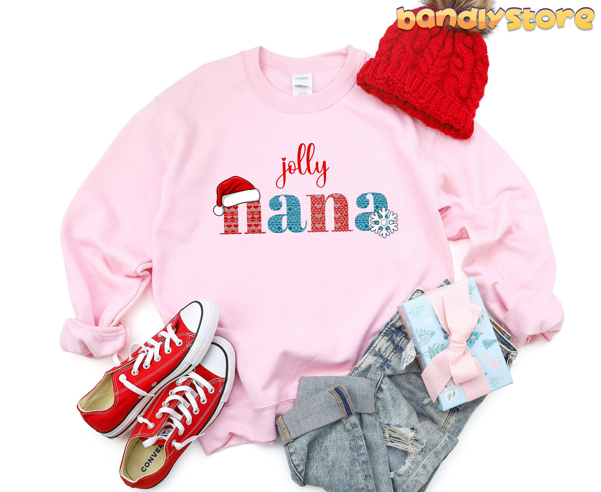 Jolly Nana Sweatshirt in light pink overhead flat lay with beanie, sneakers, jeans and gift.