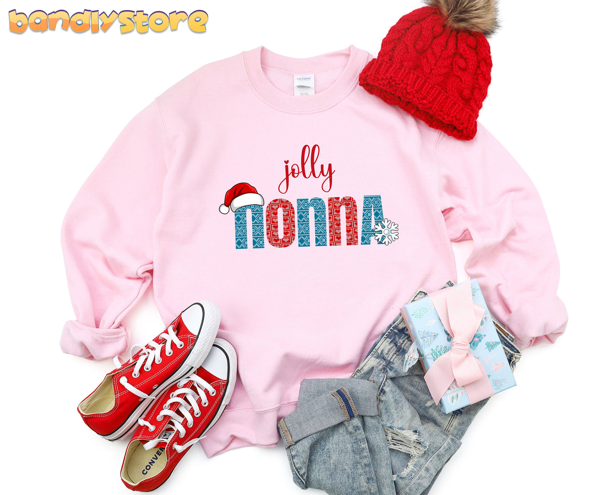 Jolly Nonna Sweatshirt in light pink in overhead flat lay with beanie, sneakers, jeans and gift.
