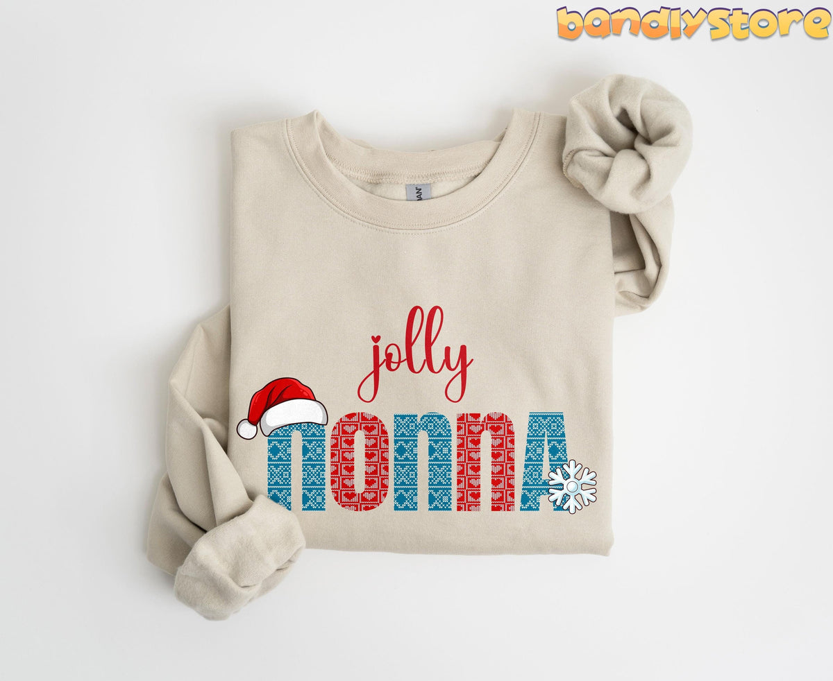 Jolly Nonna Sweatshirt in sand, folded neatly on a plain white surface with sleeves tucked.