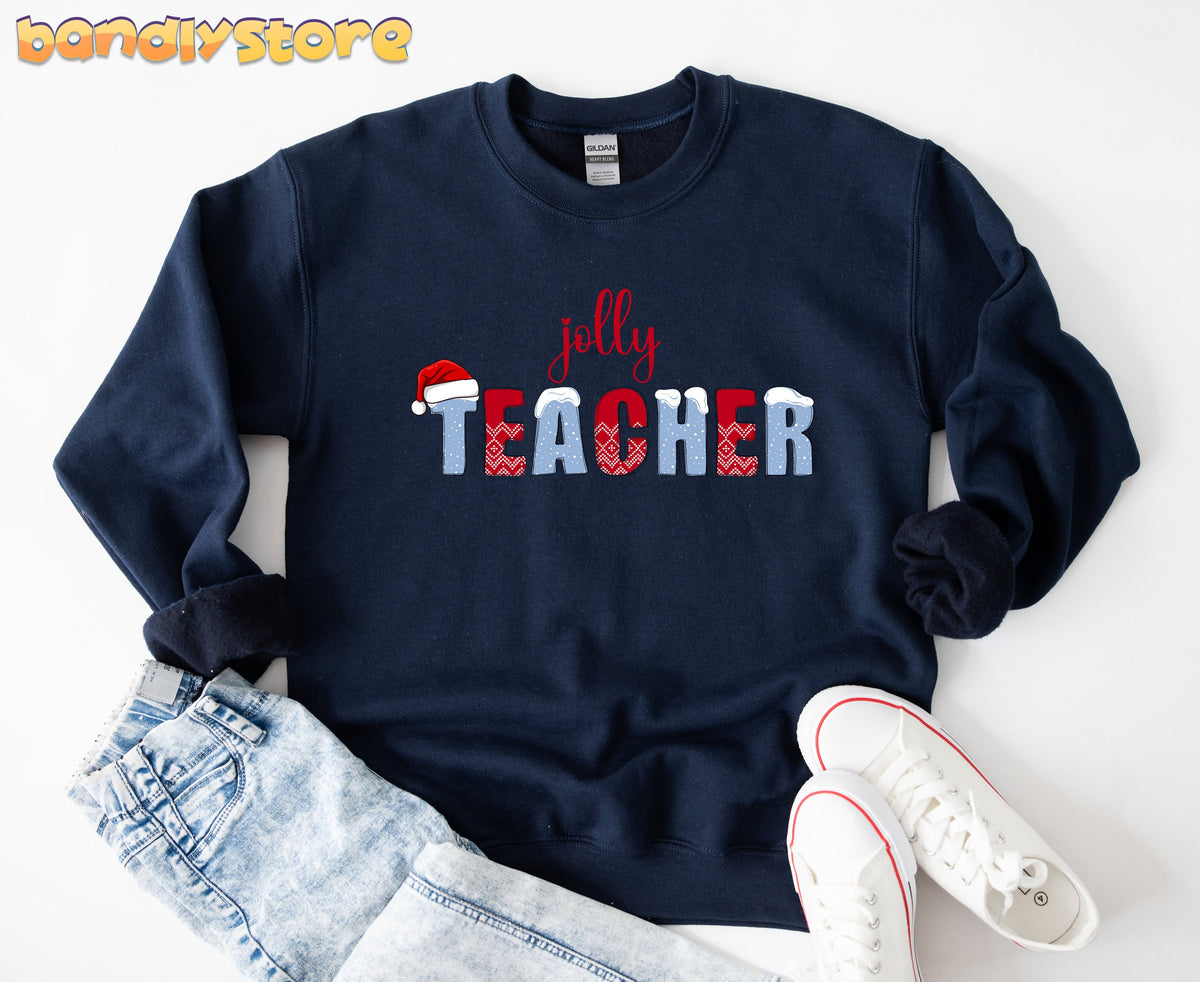 Jolly Teacher Sweatshirt in navy laid flat on white beside jeans and sneakers.