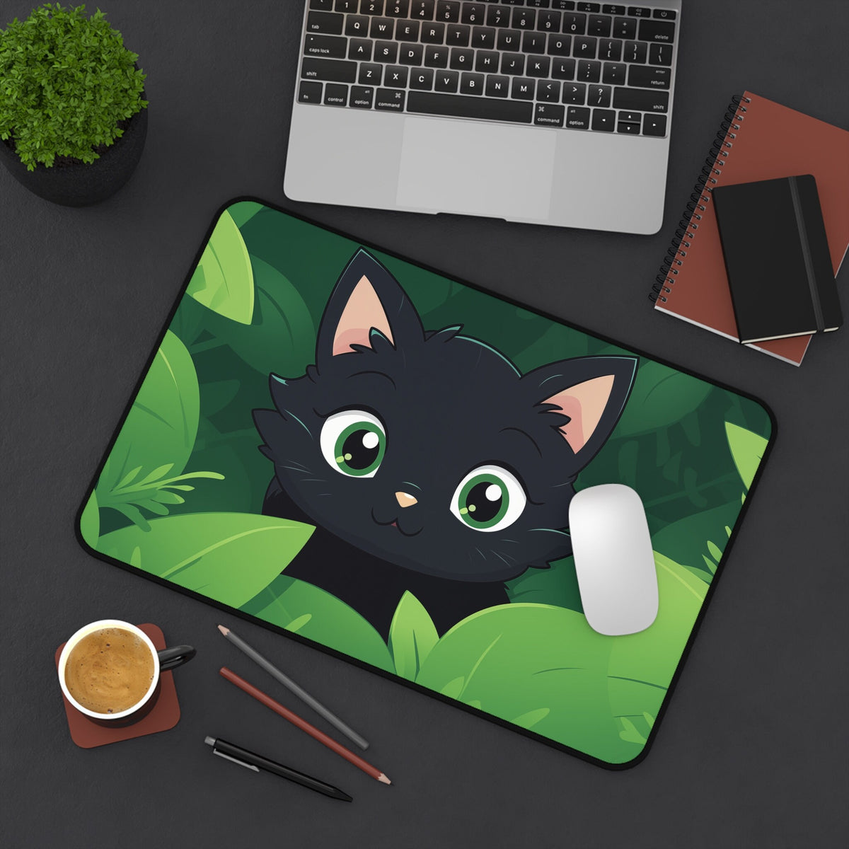 Cute Kawaii Black Cat Desk Mat 12 × 18 inches overhead on a desk with laptop, plant, notebooks, mouse, coffee and pencils.