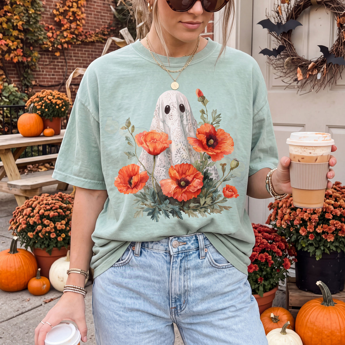 Vintage Lace Ghost Poppies T-Shirt in bay on person facing camera outdoors amid pumpkins, flowers and coffee cups.