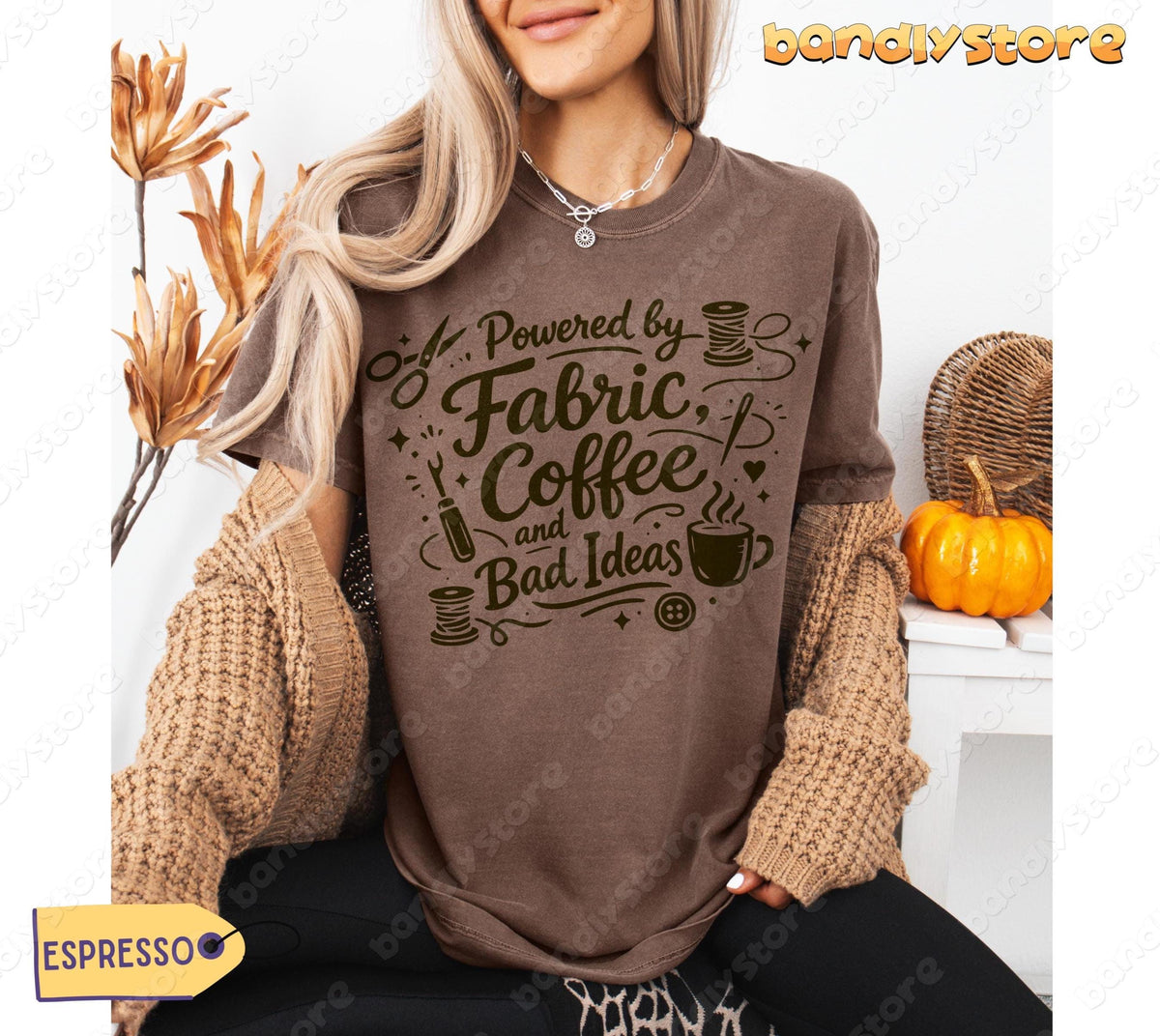 Linocut Sewing T-Shirt in espresso on seated model amid dried flowers, pumpkin and woven basket.