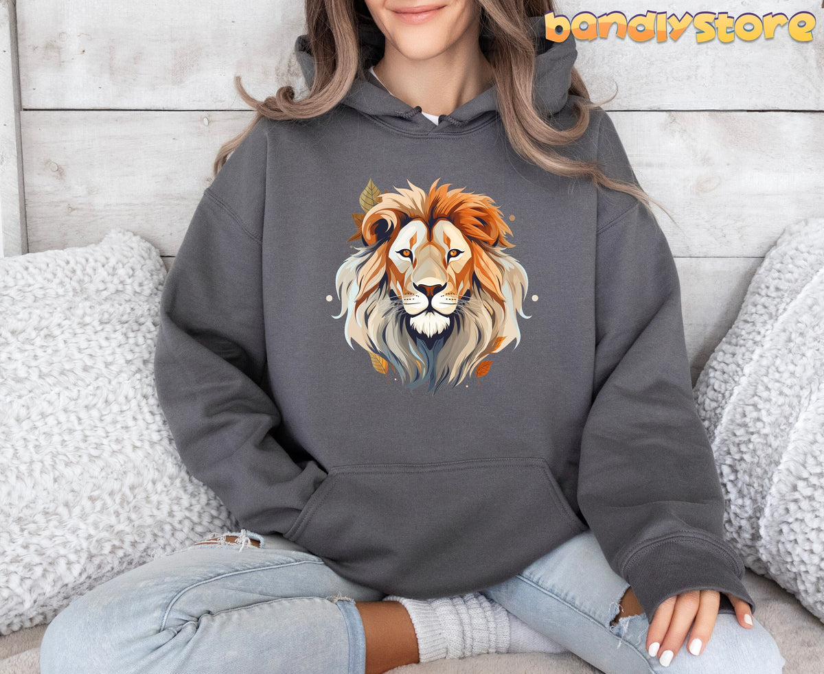 Majestic Lion Hoodie in charcoal, front view on a seated person amid white pillows and wood wall.