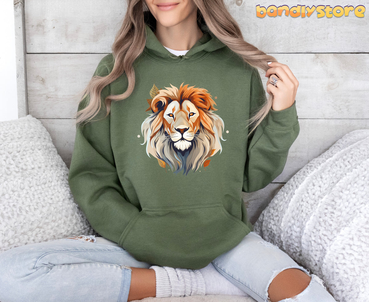 Majestic Lion Hoodie in military green on a front-facing seated person amid white pillows and wooden wall.