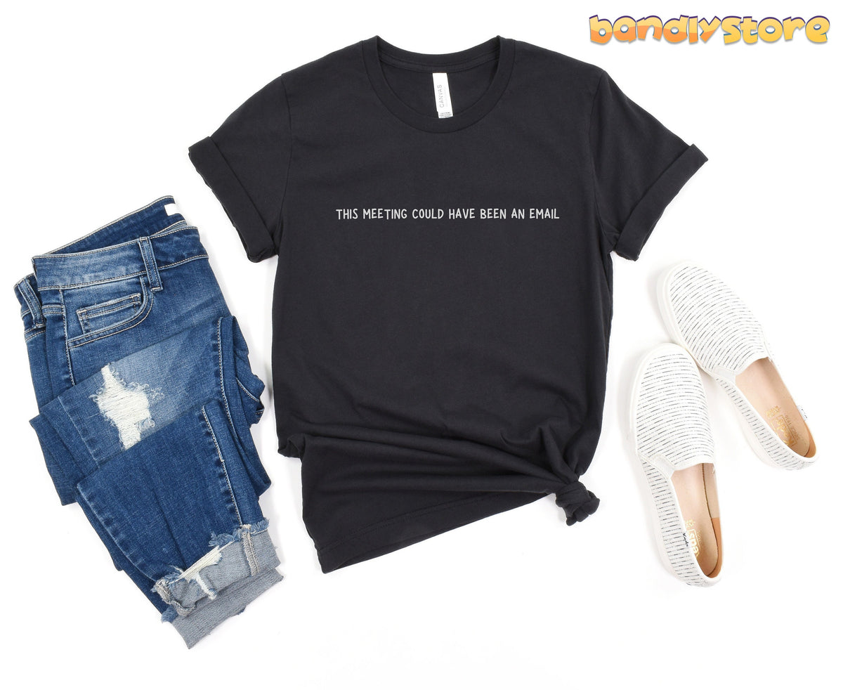 This Meeting Could Have Been An Email T-Shirt in black flat-laid beside ripped jeans and white slip-ons.