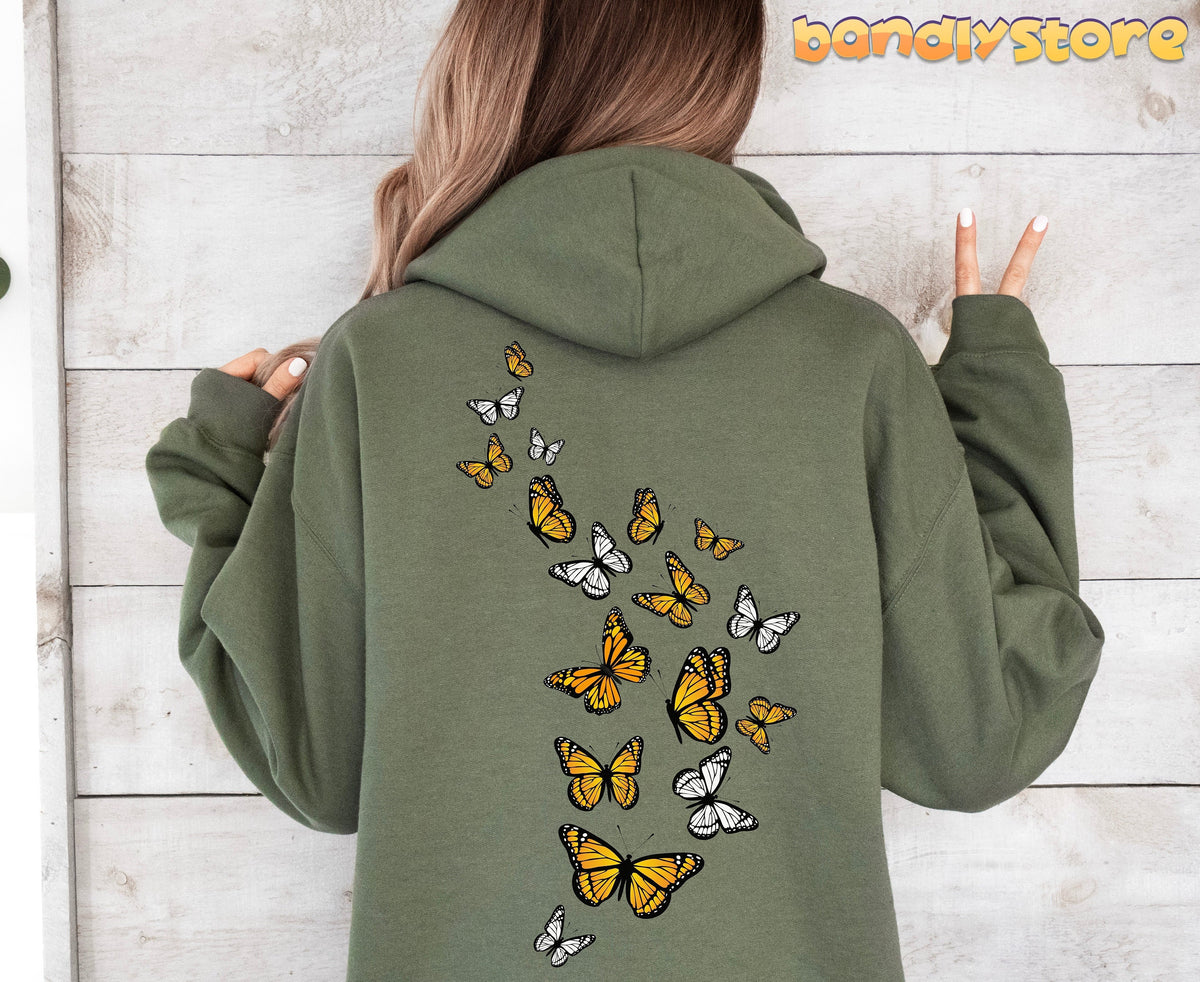 Monarch Butterfly Hoodie in military green back view on a person against a light wood wall.