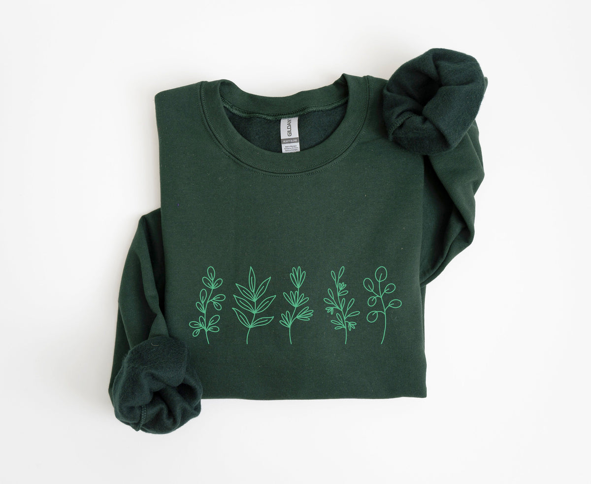 Monochrome Floral Sweatshirt forest green, folded flat on white with light green botanical line art across the chest.