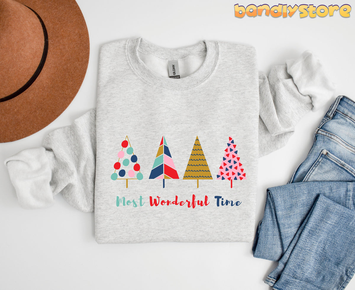 Most Wonderful Time Christmas Trees Sweatshirt in ash laid flat beside a brown hat and blue jeans