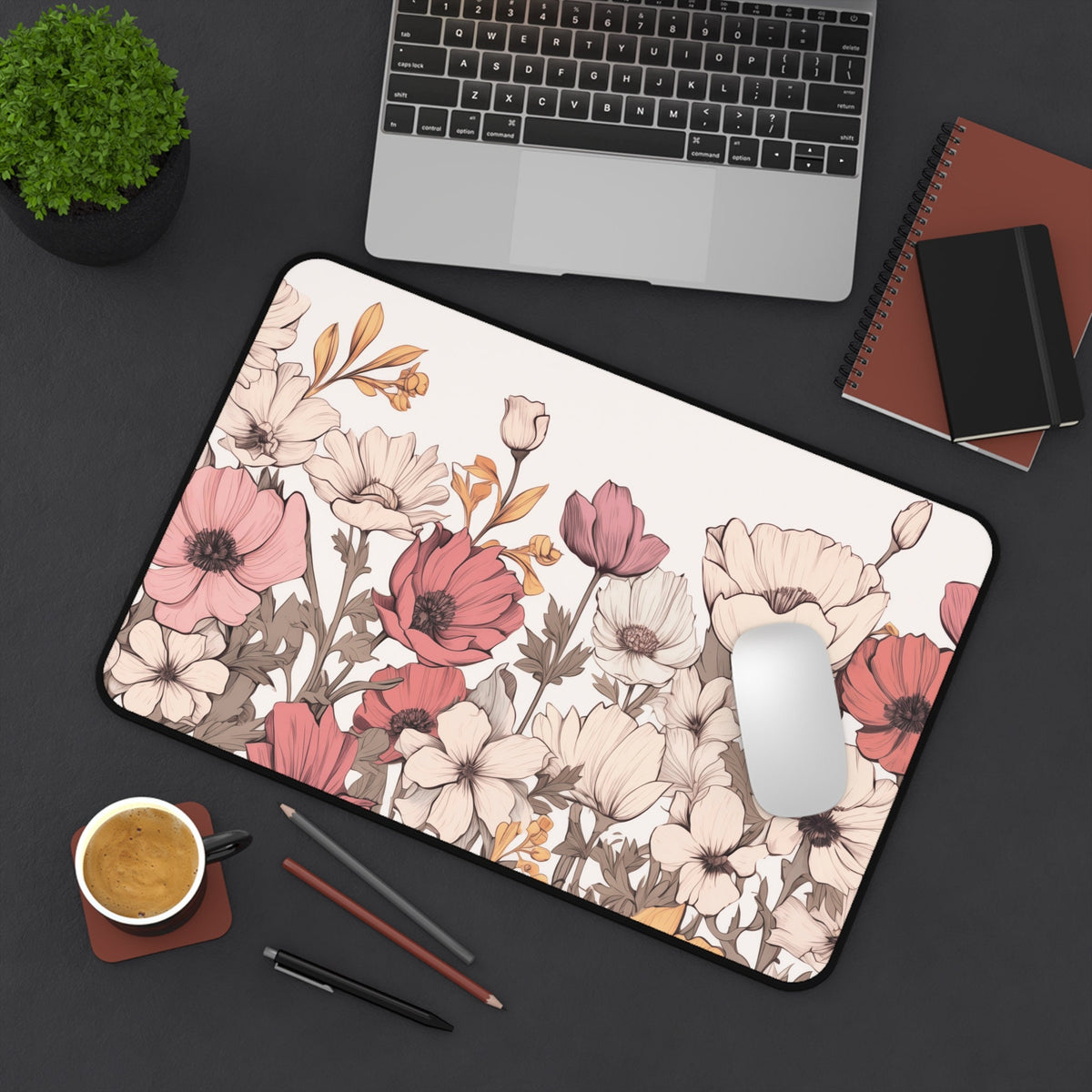 Pastel Floral Desk Mat in overhead view on dark desk with laptop, mouse, plant, coffee, pens and notebooks, 12 × 18 inches.