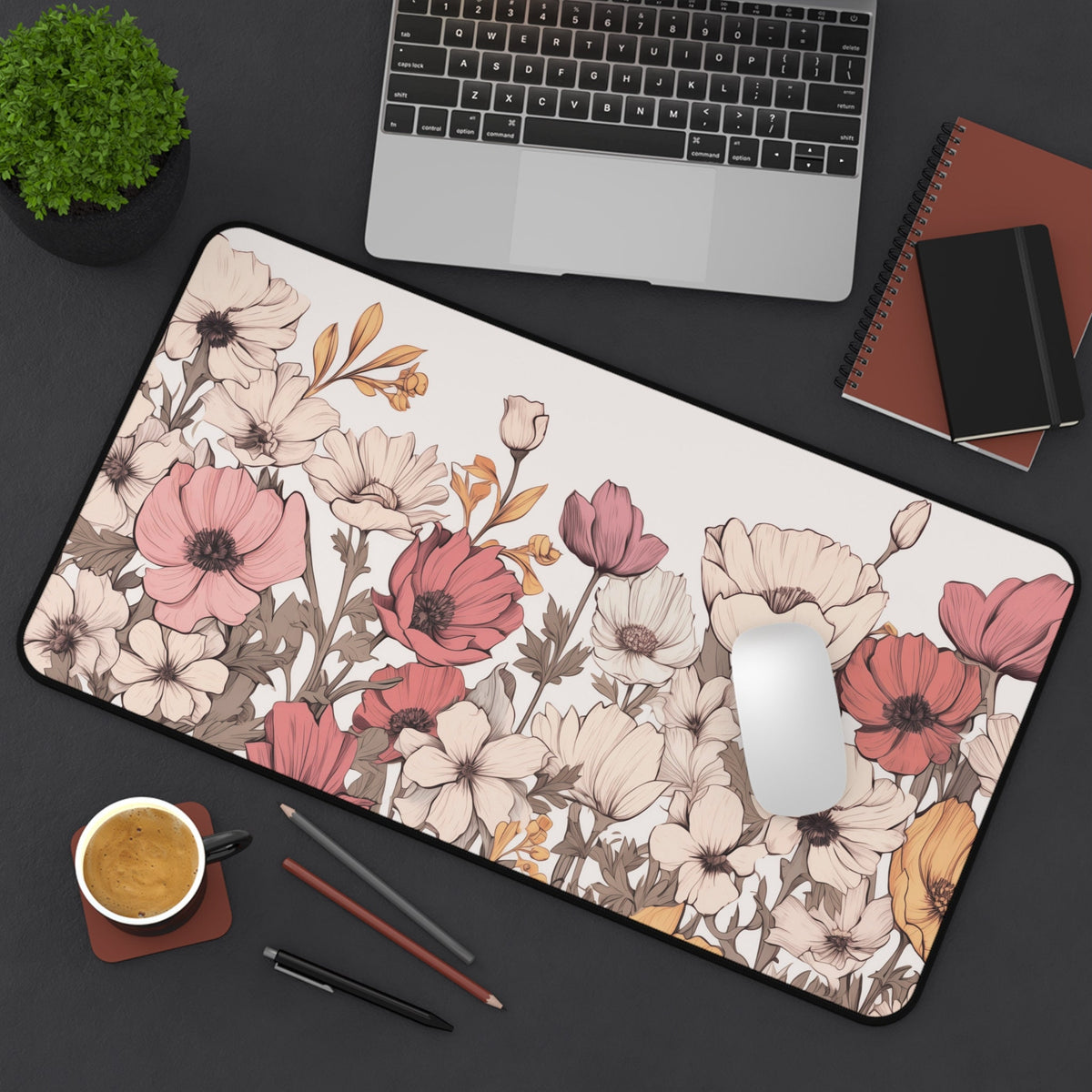 Pastel Floral Desk Mat on a dark desk under a laptop, with mouse, coffee, plant, notebooks and pencils; 12 × 22 inches.