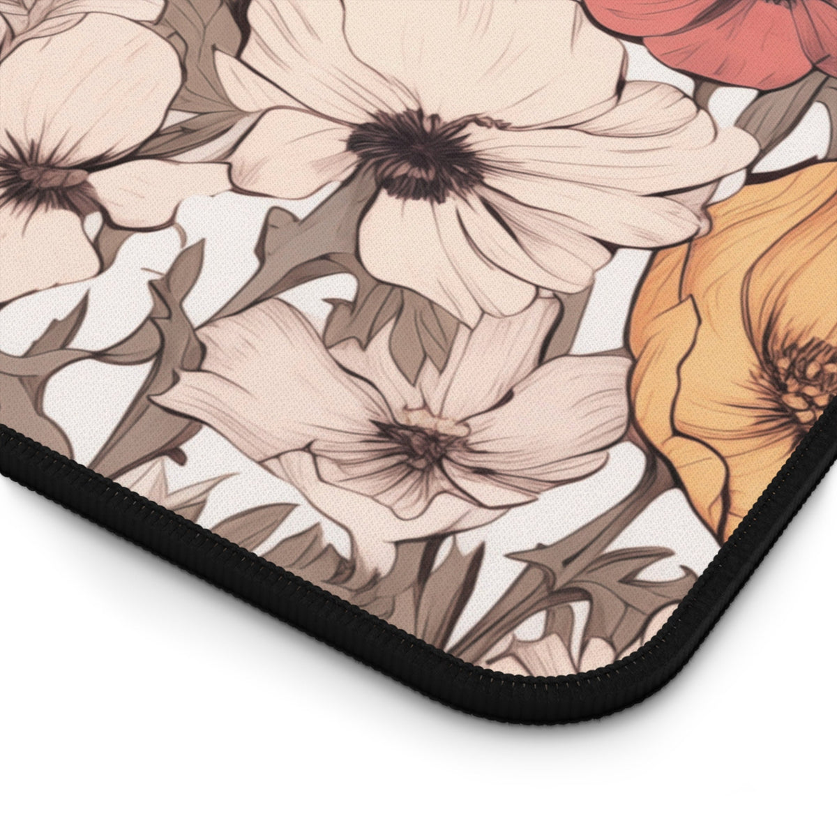 Pastel Floral Desk Mat angled close-up of the black-stitched corner with floral print on white.
