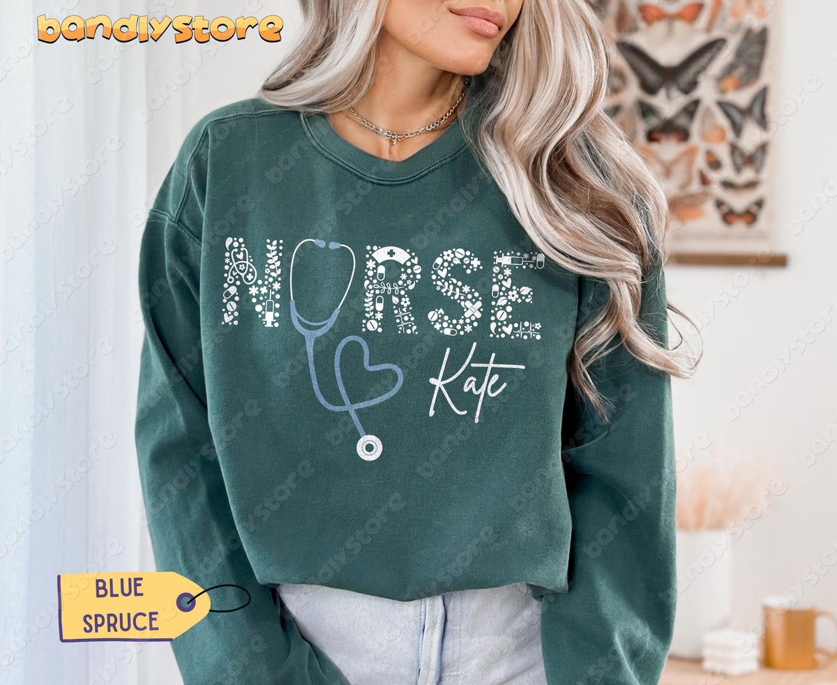 Personalized Nurse Sweatshirt in Blue Spruce on a model facing forward indoors with butterfly wall art.