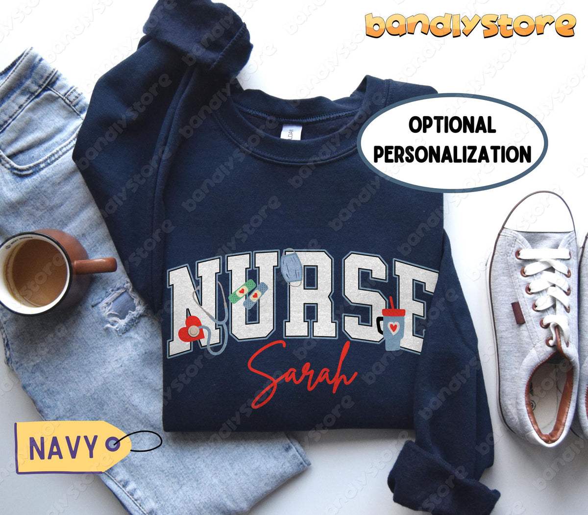 Personalized Nurse Sweatshirt in navy, overhead flat lay beside ripped jeans, coffee mug and sneakers.