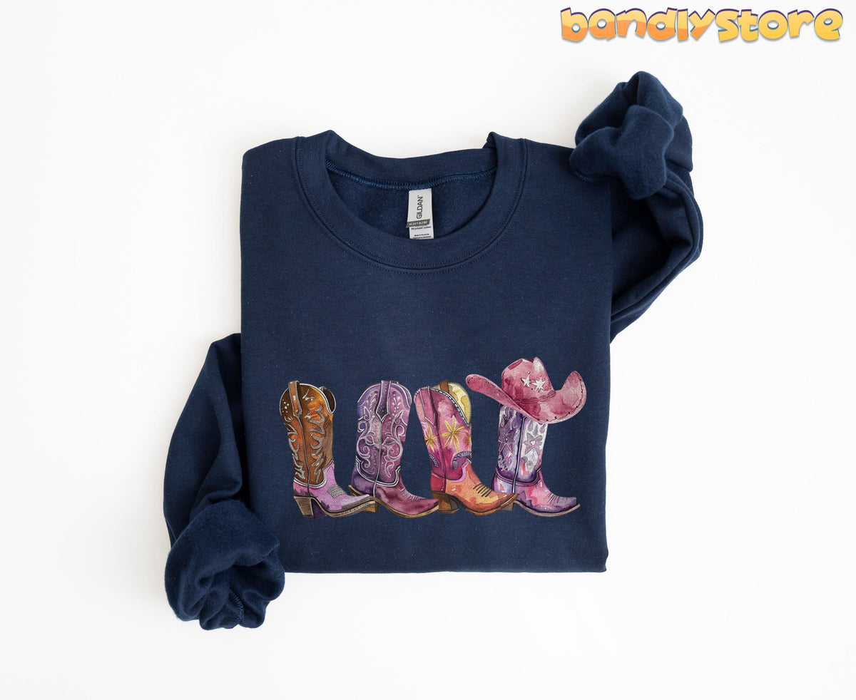 Pink Cowgirl Boots Sweatshirt on navy fabric, folded flat with colorful cowboy boots and pink hat print centered.