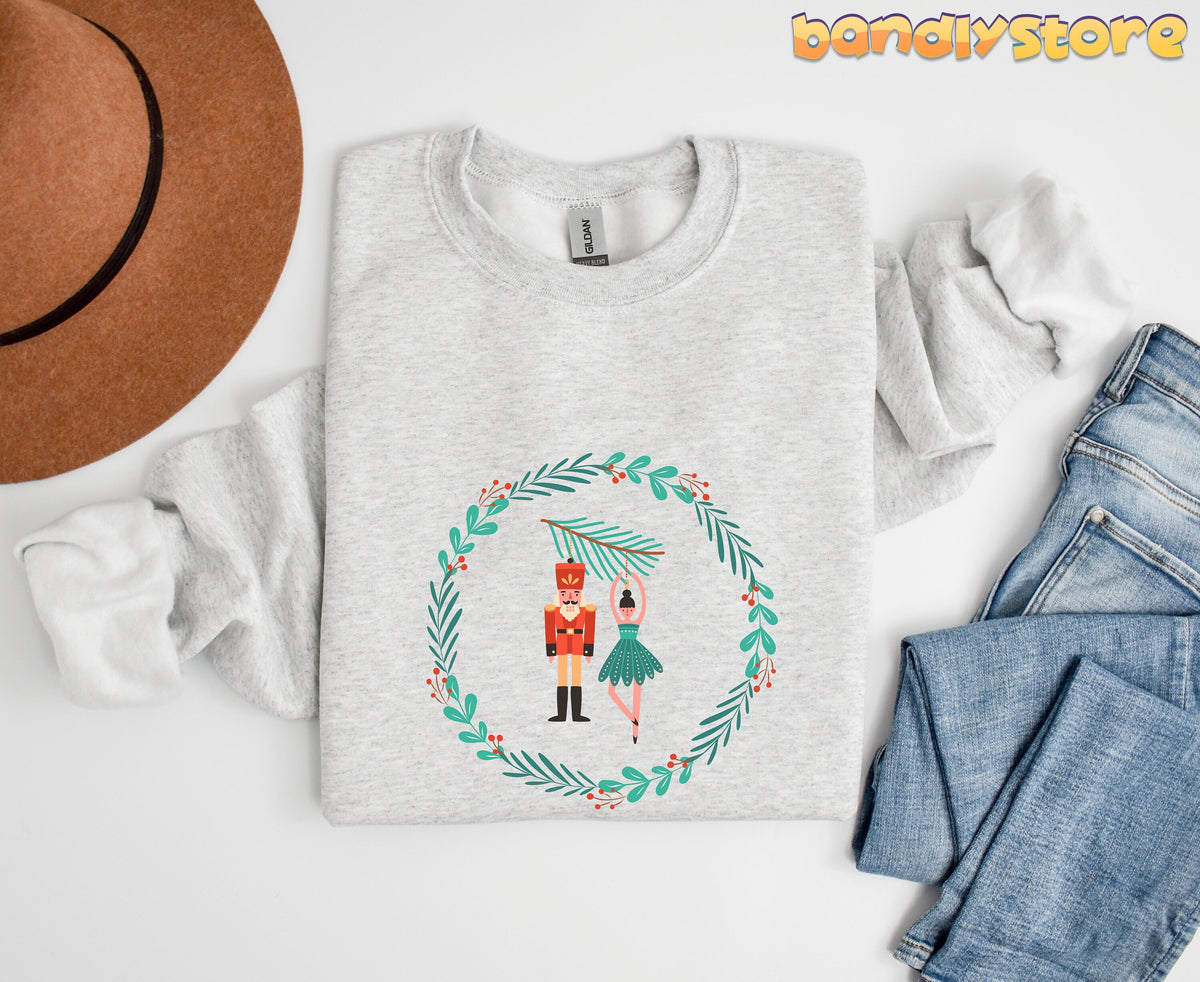 Nutcracker Ballet Sweatshirt in ash shown flat from above beside a brown hat and blue jeans.