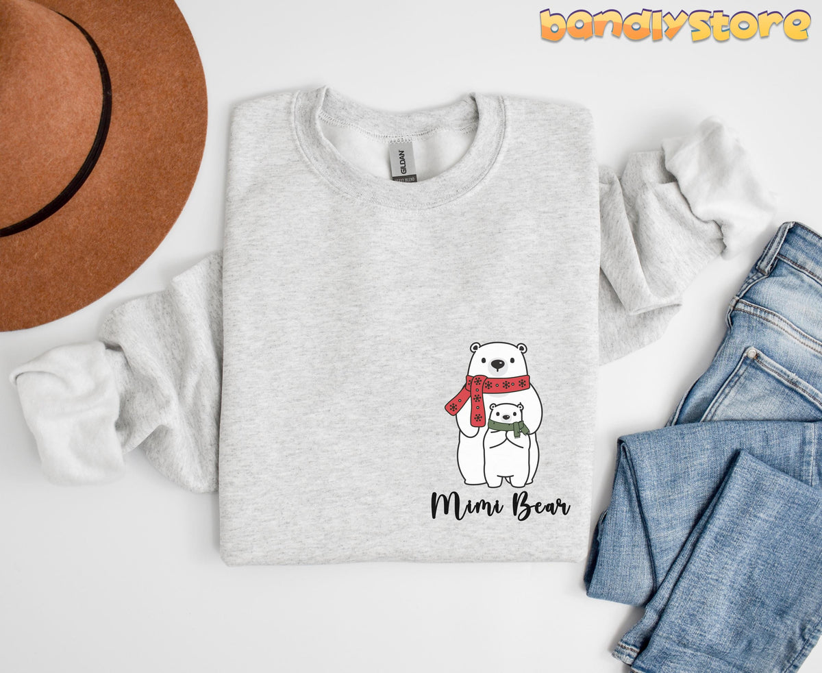 Pocket Mimi Bear Sweatshirt in ash folded flat from above beside a brown hat and blue jeans.