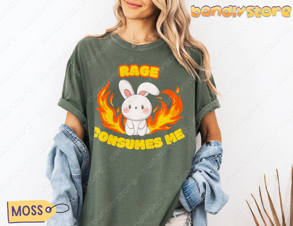 Rage Consumes Me T-Shirt in moss on a forward-facing model holding a denim jacket against a white wall.