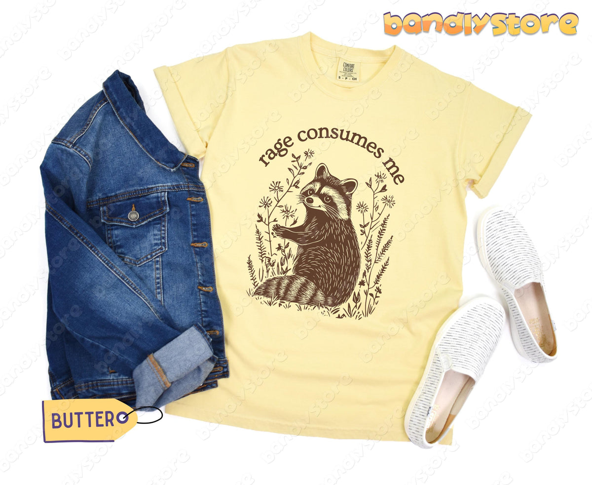 Rage Consumes Me T-Shirt in butter flat-laid with denim jacket and slip-on shoes.