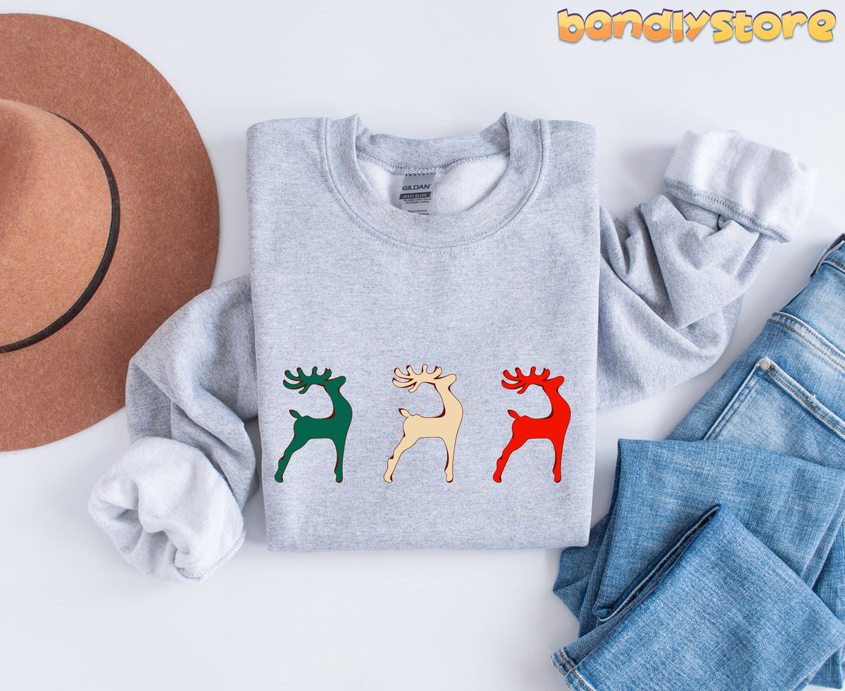 Reindeer Christmas Sweatshirt in Sport Grey laid flat with brown hat and blue jeans on white background.