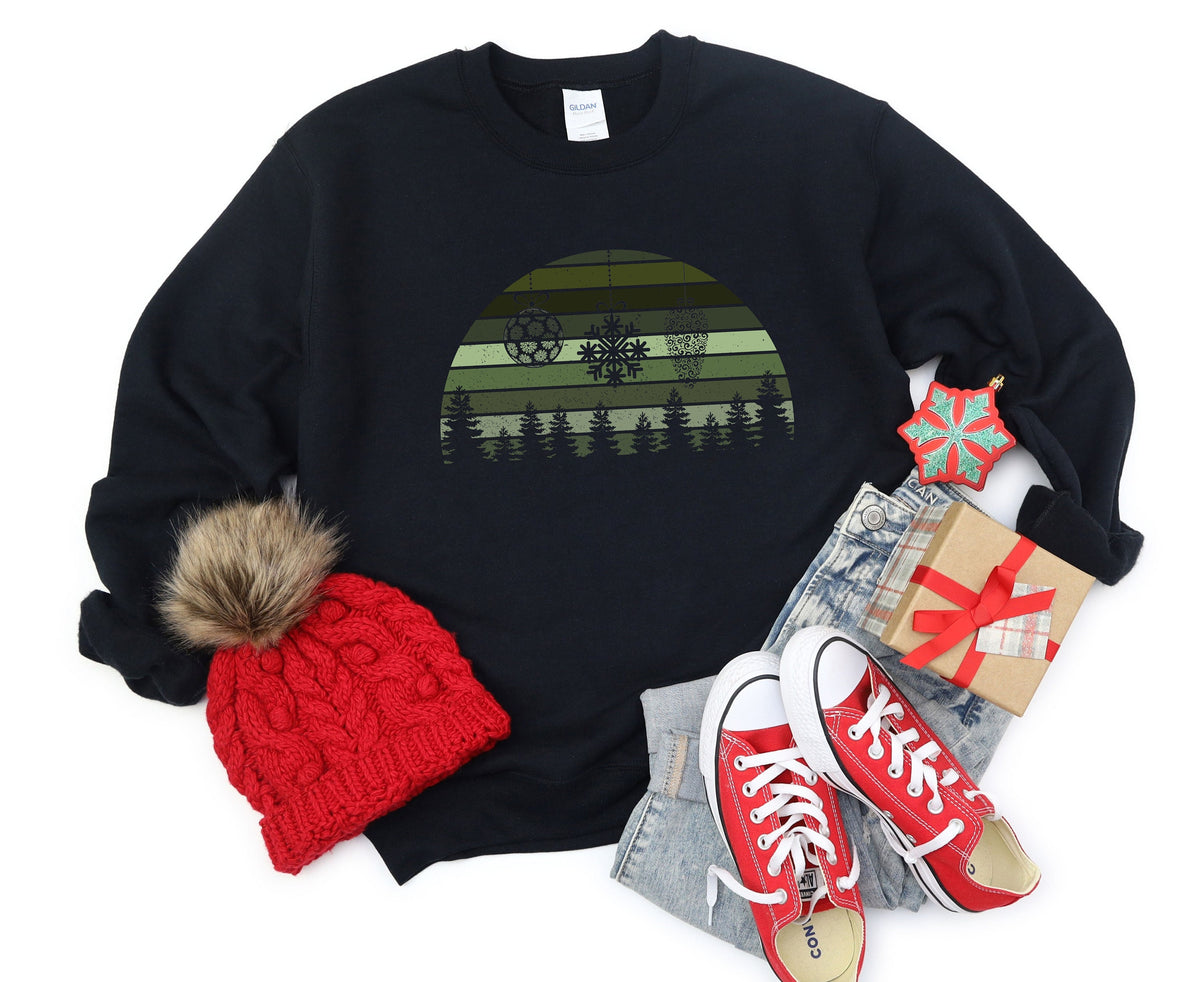 Retro Christmas Sweatshirt on black fabric, flat lay with red beanie, red sneakers, jeans, gift and snowflake ornament.