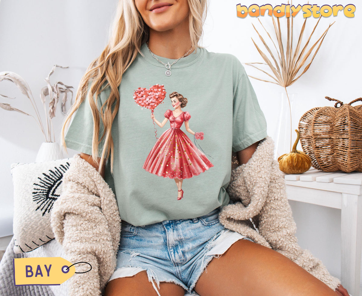Cute Valentine Girl T-Shirt in bay on a model sitting indoors among dried plants, pillow, pumpkin and basket.