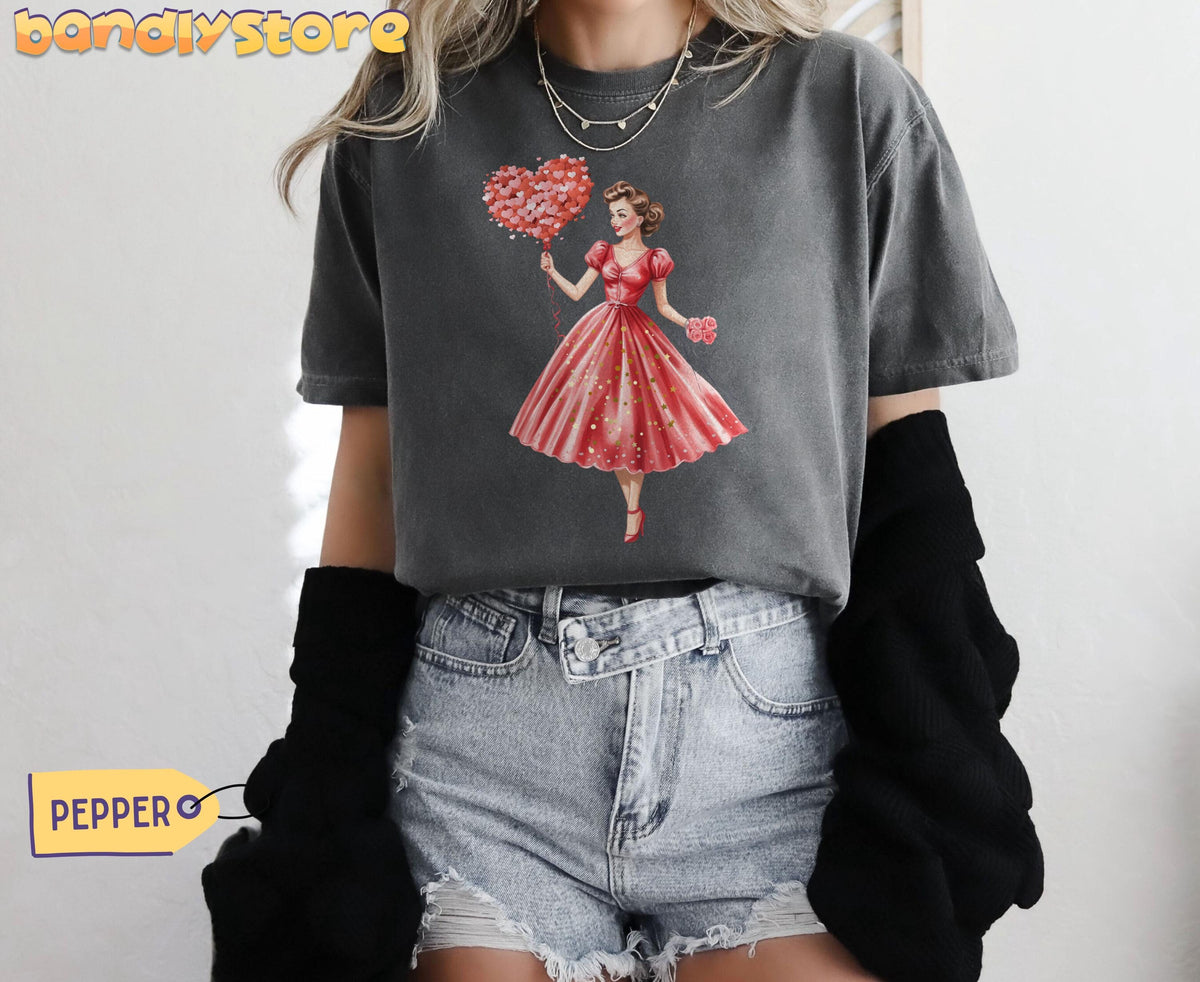 Cute Valentine Girl T-Shirt in Pepper on a model facing forward wearing denim shorts by a plain wall.