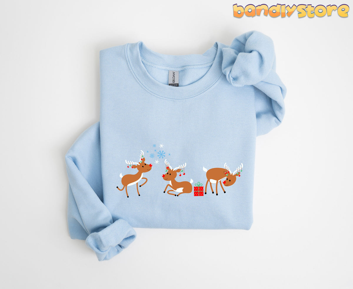 Rudolph The Red Nosed Reindeer Sweatshirt in light blue folded flat on a plain white background.