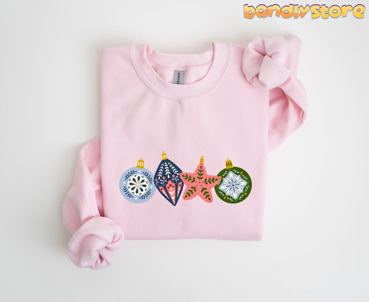 Scandinavian Christmas Sweatshirt in light pink folded flat on a plain white background.