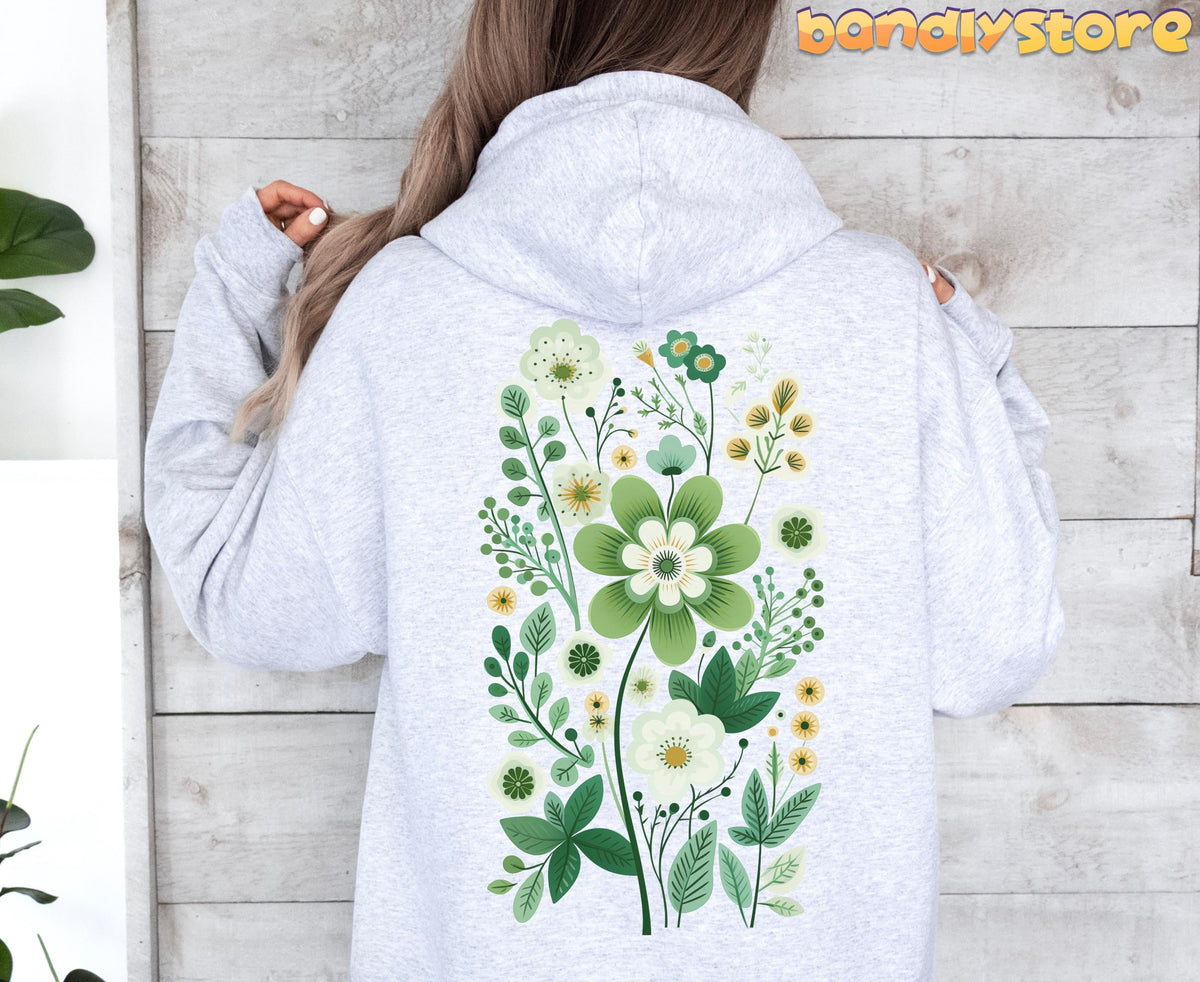 Scandinavian Wildflowers Hoodie in ash, back view against wood wall with green floral print and plant at left.