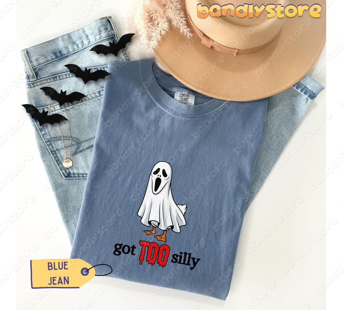 Silly Goose T-Shirt in Blue Jean, overhead flat lay with jeans, hat, bats and necklace.