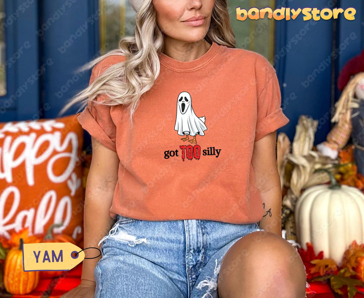 Silly Goose T-Shirt in yam, front view on a seated woman amid pumpkins and fall decor.