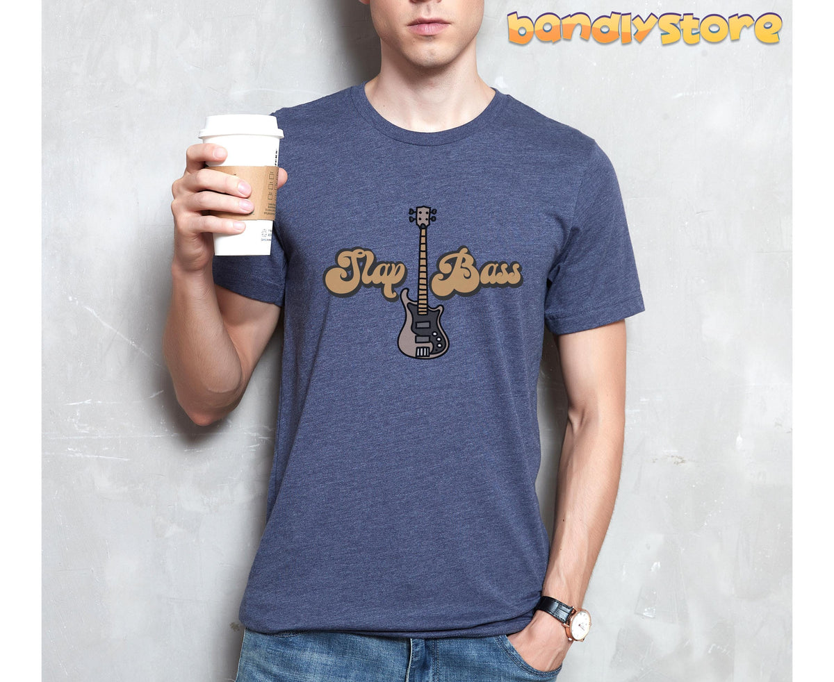Slap Bass T-Shirt in Heather Navy on a model holding a coffee cup against a gray wall.