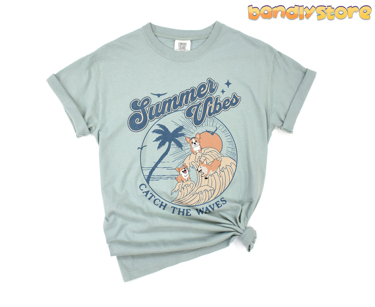 Vintage Summer Vibes Corgi T-Shirt in Bay, front view knotted at the hem with rolled sleeves on plain white.