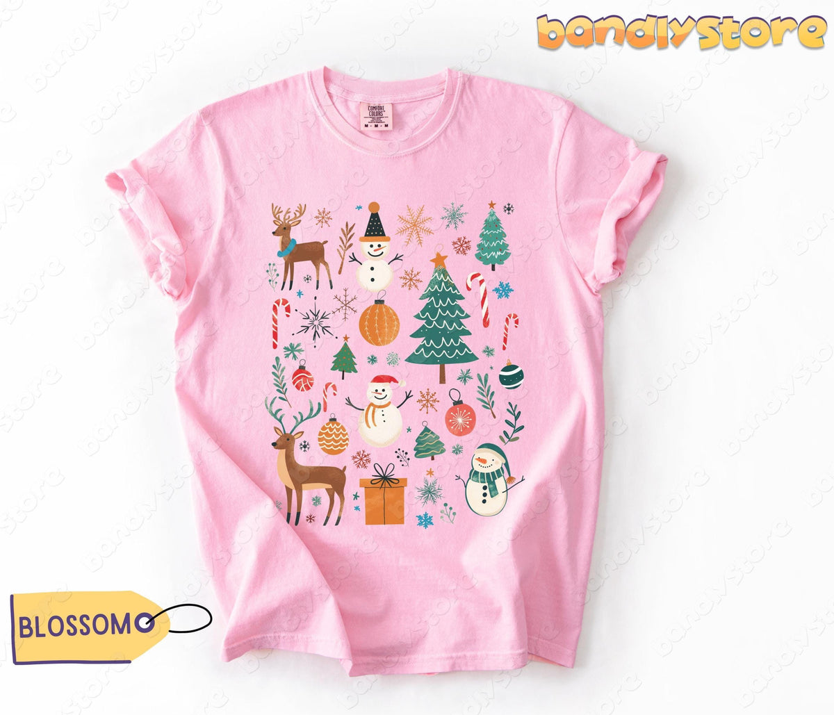 Tis The Season Christmas T-Shirt in Blossom laid flat on white with yellow tag nearby.