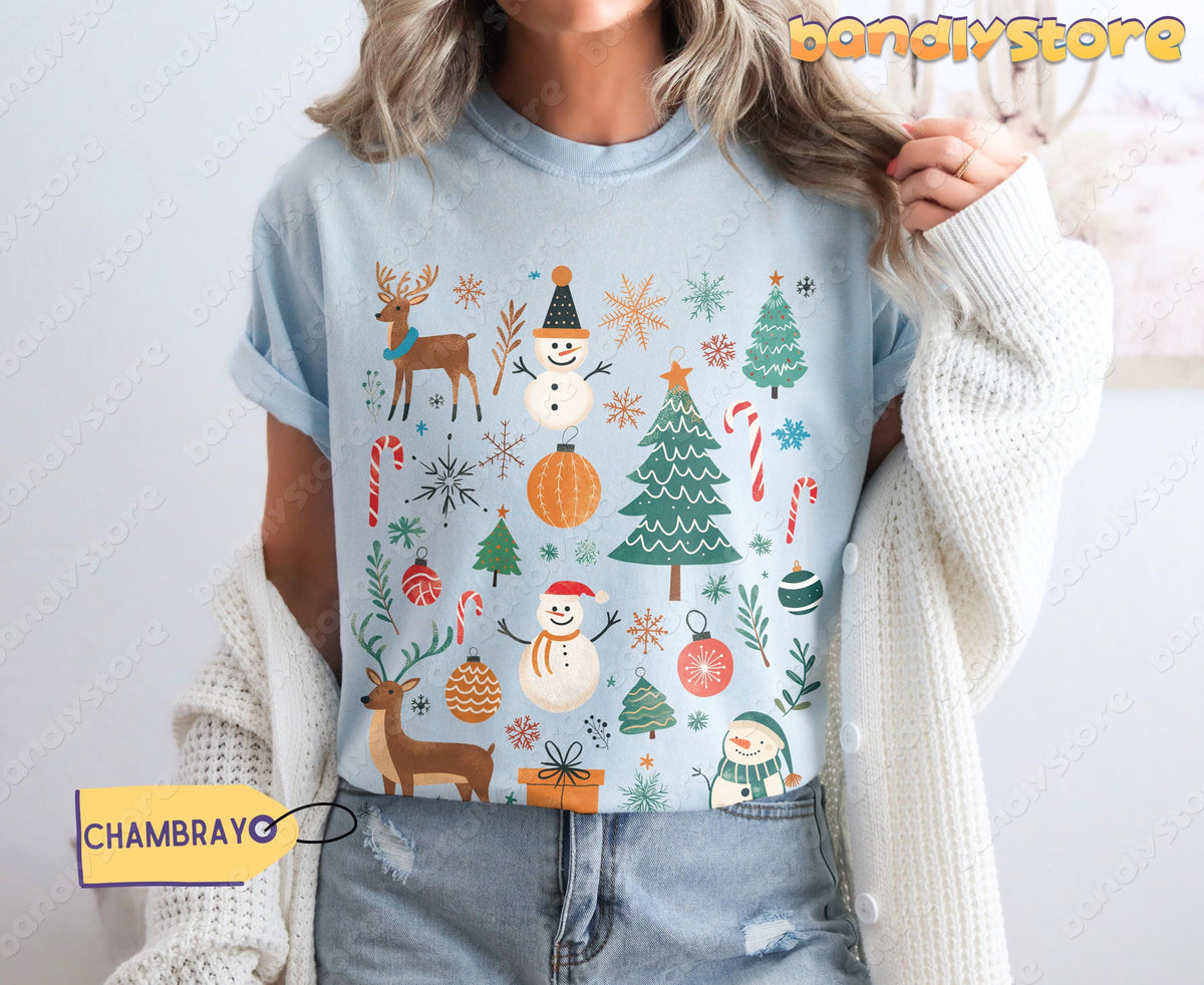 Tis The Season Christmas T-Shirt in chambray, front torso view on person with white cardigan and jeans.
