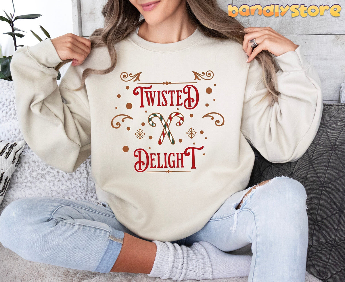 Twisted Delight Candy Cane Sweatshirt in sand on a seated model amid pillows and a plant.