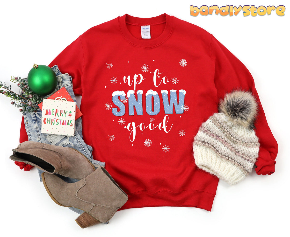 Up To Snow Good Sweatshirt in red laid flat with boots, beanie, jeans and ornaments.