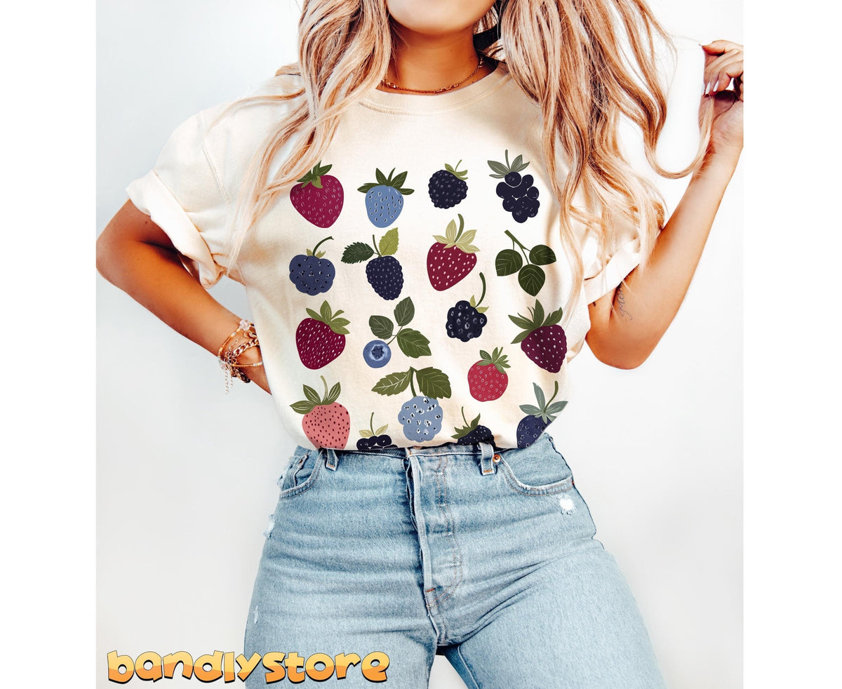 Verry Berry T-Shirt in ivory on a blonde model in jeans posing frontally against a plain white backdrop.