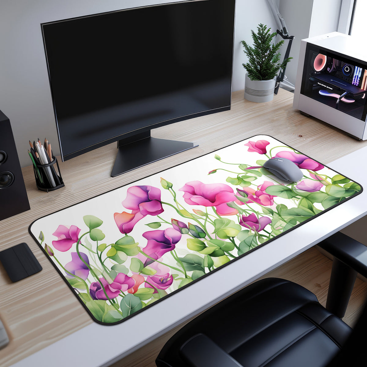 Watercolor Sweet Pea Flowers Desk Mat shown from above on a desk with a monitor, mouse, plant and PC tower.