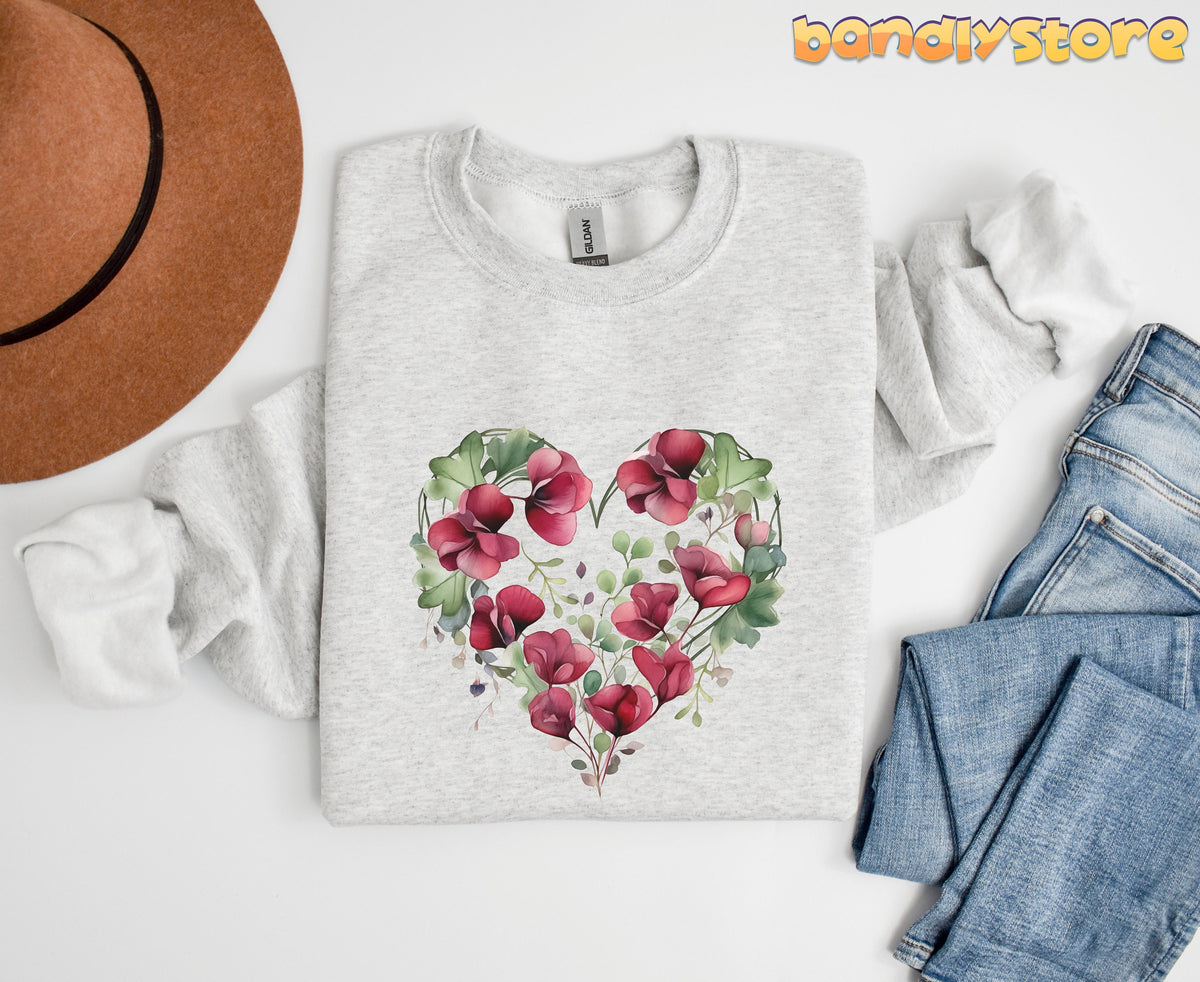 Watercolor Sweet Pea Heart Sweatshirt in ash flat-laid from above next to a brown hat and blue jeans.